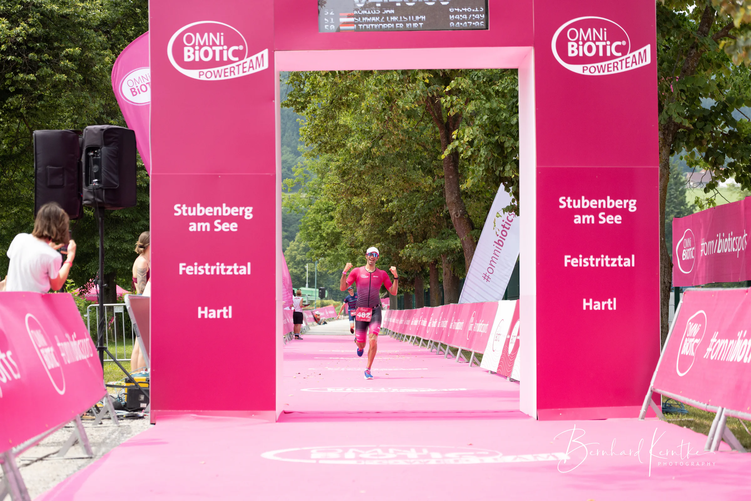 Navin läuft durch einen Triathlon-Zielbogen